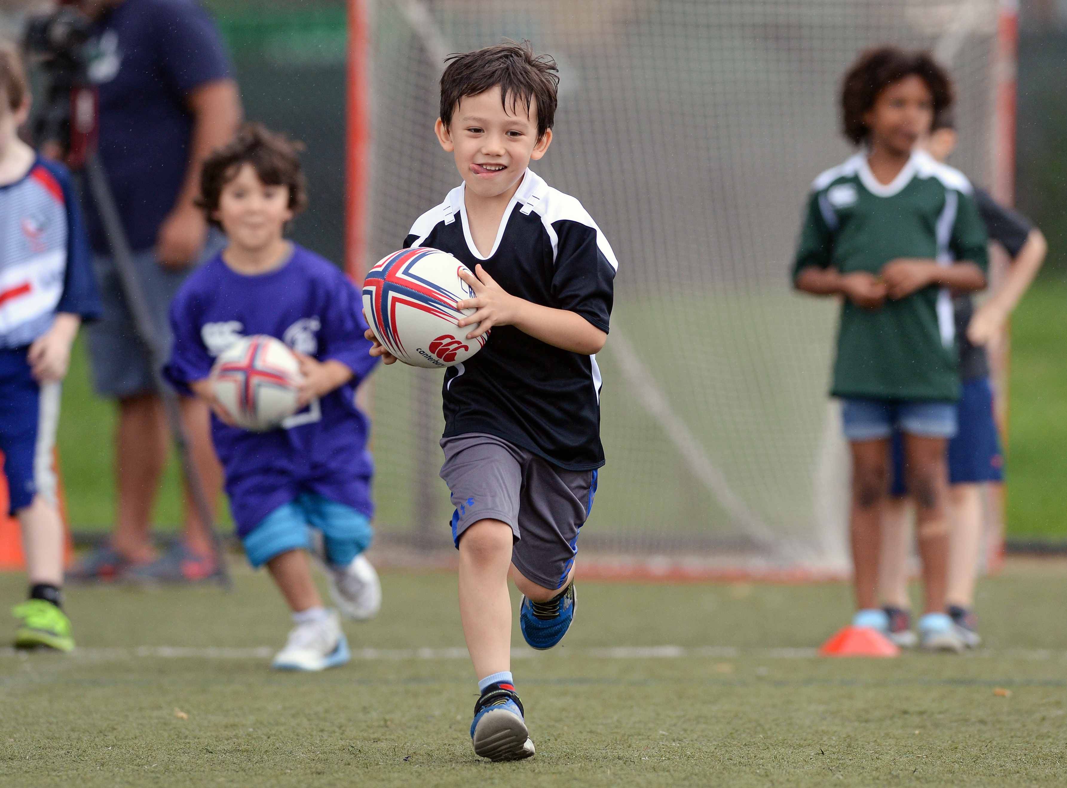 2017 AIG New York City Rugby Cup Smiling Child playing Rugby on the field